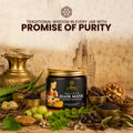 a premium amber glass jar of lep hibiscus and aloe hair mask for complete hair nutrition with a golden cap. the sleek black product label features traditional indian artwork of a woman combing her long dark hair, elegant gold typography, and the text 